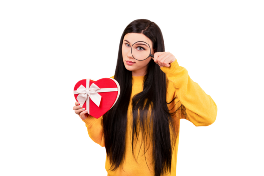girl in a yellow sweater with a gift and a magnifying glass in her hand, the concept of search for a gift isolated on transparent background
