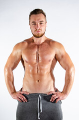Fototapeta premium Young handsome guy on a diet. A man with a beautiful athletic body. 