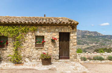 Fototapeta na wymiar Small cottage overlooking the mountains in historic village Siurana, Spain