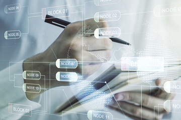 Multi exposure of abstract software development hologram with world map and man hand writing in notebook on background, global research and analytics concept