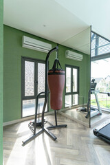 Brown punching bags hanging in sport club. Gym for fitness workout.