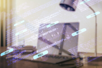 Multi exposure of abstract software development hologram with world map on laptop background, global research and analytics concept