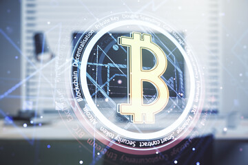 Double exposure of creative Bitcoin symbol with modern laptop on background. Cryptocurrency concept