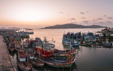 Fototapeta na wymiar Songkhla,Thailand- 8 March 2023: Spectacular fishing boats in the harbor of Songkhla at twilight.