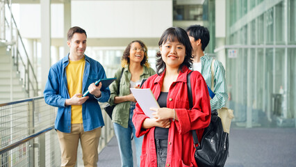 Multinational group smiling inside the building. International students.