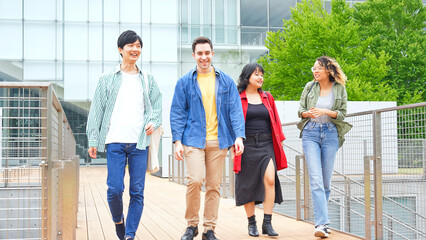 Multinational youth group walking in college campus. College students.