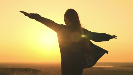 sun girl. happy young woman hands up sunset sky. joy sun. faith religion. journey women freedom. weekend vacation vacation nature. happiness unity nature. hands up sky. sun glare hand. wind hair