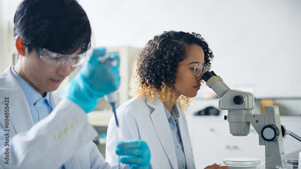 Aufkleber multinational researcher group experimenting in the lab.