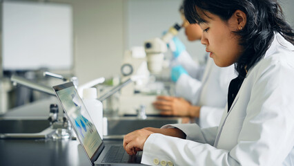 Female researcher looking at a molecular model. science student.