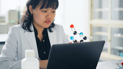分子模型を見る女性研究者