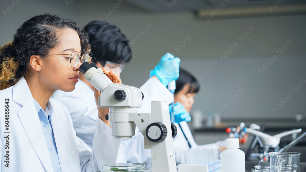 Poster multinational researcher group experimenting in the lab.