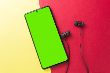 Big wireless headphones and phone. Chromakey space on the phone screen