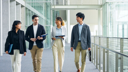 Multinational business group walking through lobby. Global business.