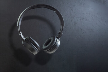 Fototapeta na wymiar Large wireless headphones on a dark background