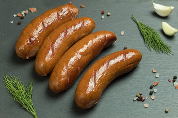 Grilled meat sausages. Fried sausage. Fried anchovies preparing for consumption.