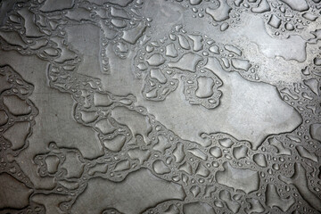 a photo of rain  droplets on surface of shine inox
