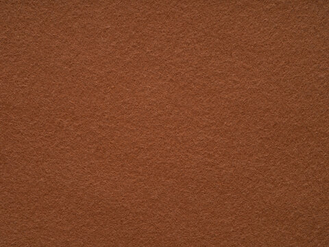Brown felt fabric material texture. Full frame large matt backdrop wallpaper. Matt retro velvet pattern or vintage background in high resolution. Natural wool for text, lettering, patchworkor 3d art.
