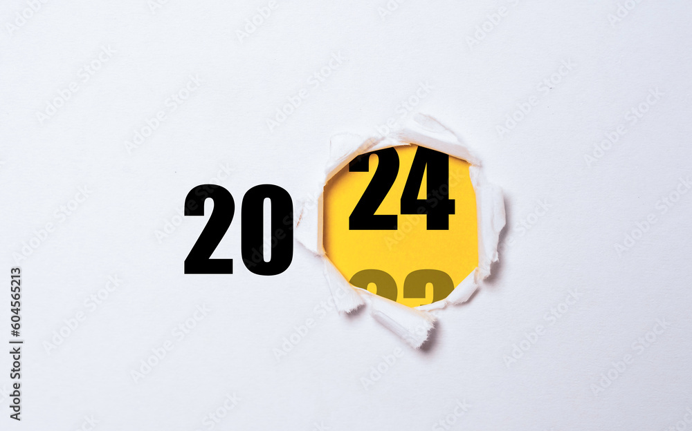 Poster changing of year from 2023 to 2024 inside of yellow punch paper for start business preparation in ne