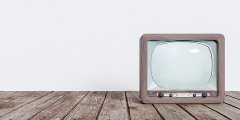 Old fashioned vintage brown television placed on wooden floor