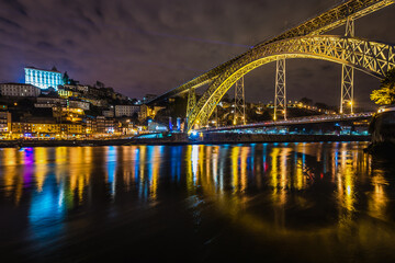 Fototapeta na wymiar Evenieng view of Porto city, Portugal. View from river bank in Vila Nova de Gaia city