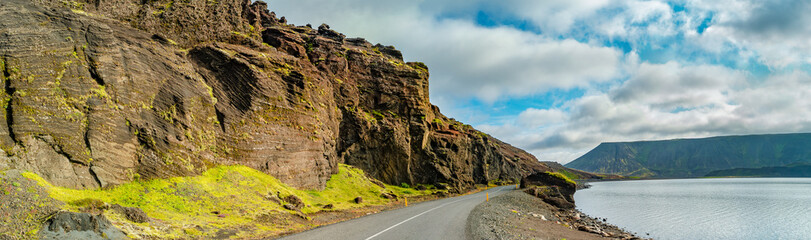 Panoramic over Icelandic colorful and wild landscape with volcanic black sand beach at the...