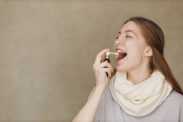 Young woman has flu catarrh ill sick disease treatment cold hold medicine nasal spray