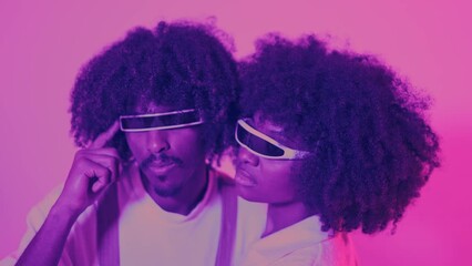 Serious african couple embracing while using futuristic eyeglasses - Powered by Adobe
