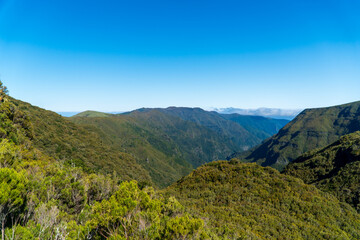Fototapeta na wymiar Mountain landscape. View of mountains on the route Queimadas Forestry Park - Caldeirao Verde. Madeira Island, Portugal, Europe.