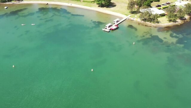 Murrays beach village Lake Macquaire resort beach in aerial top down 4k.
