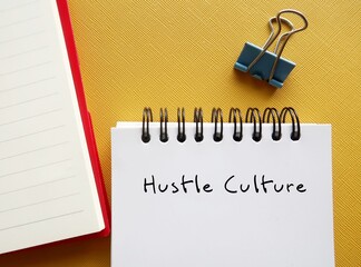 Notbook on yellow background with handwritten text HUSTLE CULTURE - lifestyle where career has...