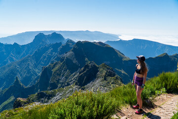 Beautiful tuorist woman stay on point of the island Madeira. View from Pico Ruivo in Madeira the highest in Portugal