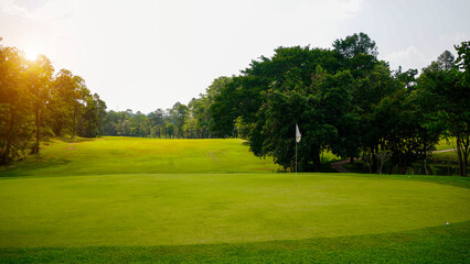 Beautiful golf course in a sunny day. Background evening golf course has sunlight shining down.