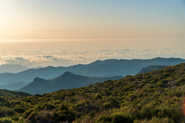 Fototapeta na wymiar Sunrise in Madeira mountains peaks in sunlight, scenic view over landscape and Pico Ruivo, Portugal.