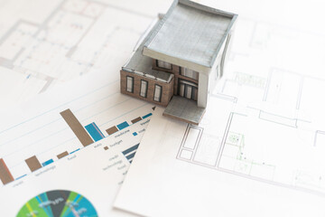 Volumetric project of house. Layout of a house with an open roof. Miniature layout of a cottage top view. Building model as a symbol of architectural business. Design in architectural bureau