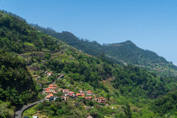 Fototapeta na wymiar Mountain landscape with vegetation beautiful background of Madeira mountains. Green landscape cloudy sky