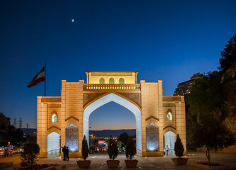 Night view of Historical Quran Gate at Allahu Akbar gorge with the city on background in Shiraz, Fars Province, Iran. Tourist attraction.