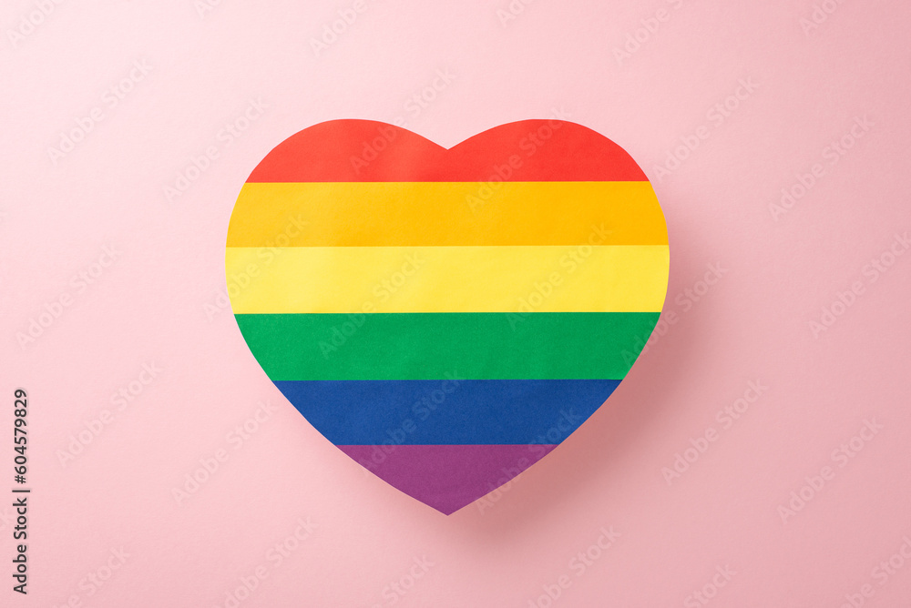 Wall mural a top-view image of lgbt support symbol, big rainbow colored heart, displayed on a pastel pink backg