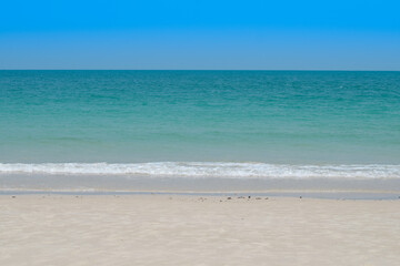 beautiful sandy beach and soft blue ocean wave. summer background concept