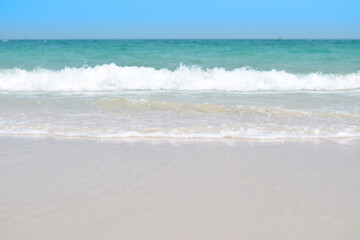 Fototapeta na wymiar beautiful sandy beach and soft blue ocean wave. summer background concept