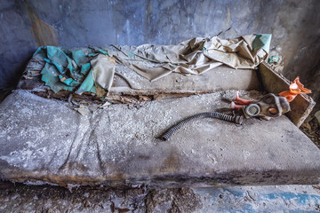 Gas mask on a sofa in residential building in abandoned military base in Chernobyl Exclusion Zone, Ukraine