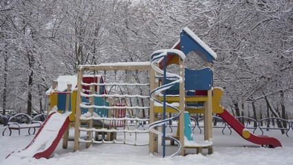 a beautiful playground in winter,in winter, children's slides in the park are covered with snow