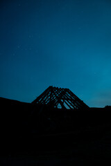 Silhouette of a roof in a blue night