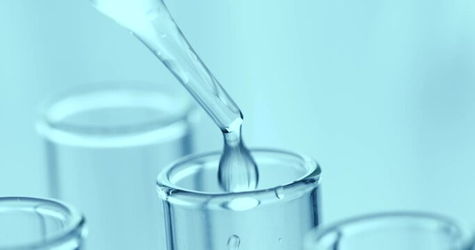 Drop chemical fluid into laboratory test tube , science biological or chemistry research concept