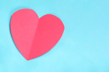 Valentine's day concept. Red paper heart on blue background. Copy space for your text.