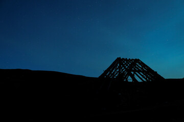 Silhouette of a roof in a blue night
