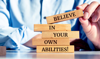 Close up on businessman holding a wooden block with a 
