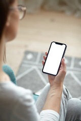 Mock up white screen blank mobile phone in woman hands holding Back view