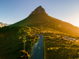 Obraz premium A couple of men and women watching the sunset at Lion's Head near Table Mountain Cape Town South Africa