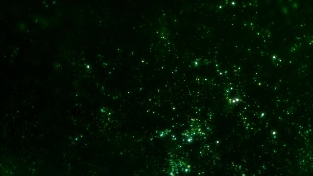 Abstract ambient VJ loop background of swirling luminous green particles. Relaxing concept 3D animation wallpaper backdrop. Magic psychedelic shimmering sparkle dust showcase and copy space backplate.