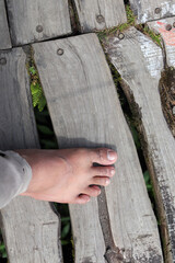 a pair of feet walking barefoot on wood. commemorating national go barefoot day